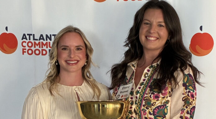 Mercer Law wins 15th Georgia Legal Food Frenzy with record amount raised Two women holding a gold trophy with a plaque, standing in front of an Atlanta Community Food Bank banner.