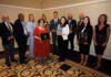 Mercer celebrates faculty achievement at 2026 awards ceremony Ten people stand in a room holding plaques and trophies, posing for an award ceremony group photo.