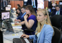 Engineering alumna part of team that launched Artemis II into space Several people sit at desks working on computers in an office setting, focused on their monitors.