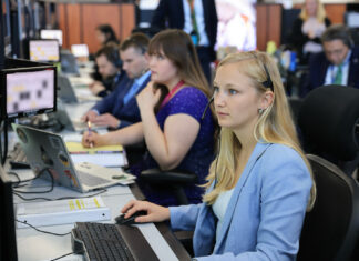 Engineering alumna part of team that launched Artemis II into space Several people sit at desks working on computers in an office setting, focused on their monitors.