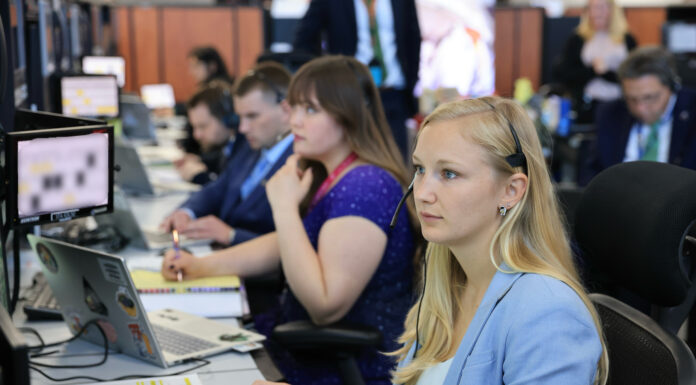 Engineering alumna part of team that launched Artemis II into space Several people sit at desks working on computers in an office setting, focused on their monitors.