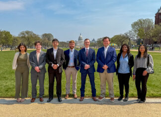Mercer Model Arab League takes home awards from national conference Eight people stand in a row outside on a path with the U.S. Capitol building visible in the background.