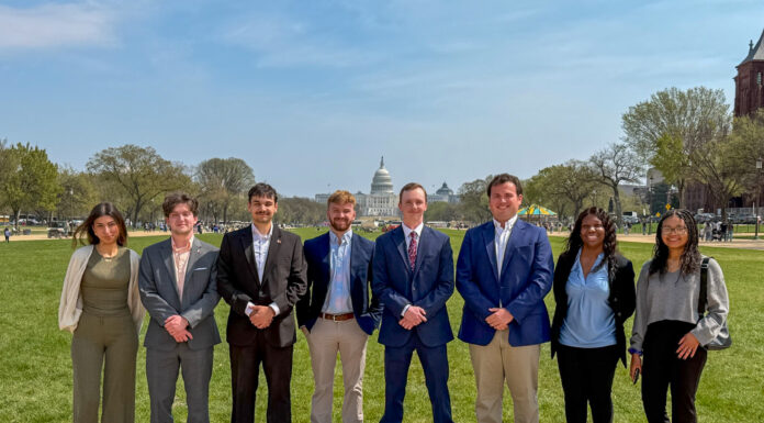 Mercer Model Arab League takes home awards from national conference Eight people stand in a row outside on a path with the U.S. Capitol building visible in the background.