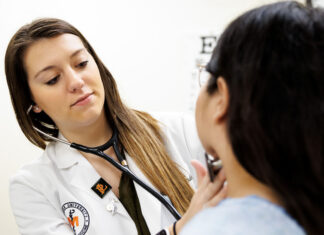 U.S. News ranks Mercer School of Medicine among best graduate medical schools A healthcare professional uses a stethoscope to examine a patient in a medical office.