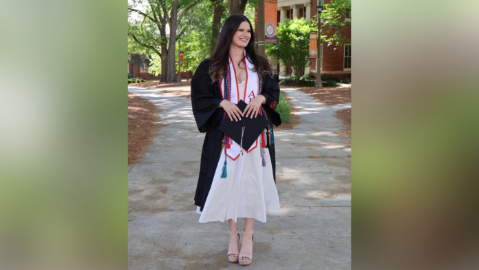Annie Potts in a graduation gown and cords.