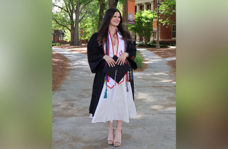 Annie Potts in a graduation gown and cords.