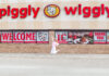 Mercer senior’s gluten-free cake mix now in stores, online Person jumps in front of a Piggly Wiggly grocery store with large red signage and welcome banners on the windows.