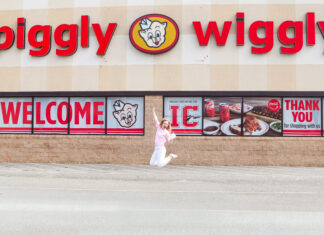 Mercer senior’s gluten-free cake mix now in stores, online Person jumps in front of a Piggly Wiggly grocery store with large red signage and welcome banners on the windows.