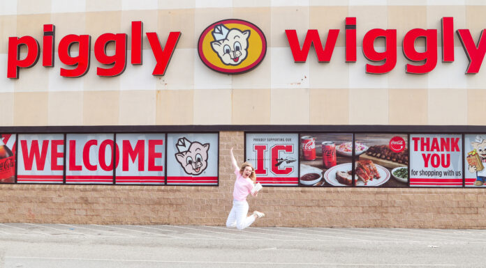 Mercer senior’s gluten-free cake mix now in stores, online Person jumps in front of a Piggly Wiggly grocery store with large red signage and welcome banners on the windows.