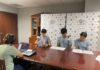 Podcast explores Georgia’s role in Revolutionary War Three teenagers read scripts at a table while a person records audio using a laptop and mixer in a small studio.
