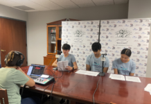 Podcast explores Georgia’s role in Revolutionary War Three teenagers read scripts at a table while a person records audio using a laptop and mixer in a small studio.
