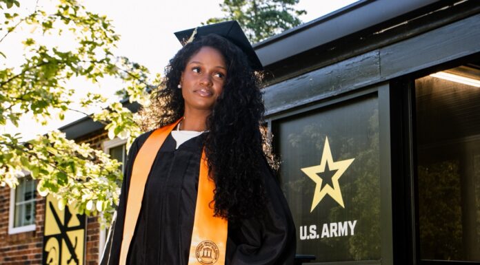 Graduate Spotlight: Beyoncé Francis Beyoncé Francis in a graduation gown and cap stands in front of a U.S. Army sign.