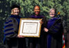 Mercer Law confers honorary Doctor of Laws degree upon the Hon. Erica L. Woodford Three women in academic regalia hold a framed Mercer University diploma at a graduation ceremony.