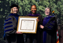 Mercer Law confers honorary Doctor of Laws degree upon the Hon. Erica L. Woodford Three women in academic regalia hold a framed Mercer University diploma at a graduation ceremony.