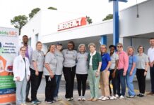 Kids Alliance for Better Care celebrates Washington County Regional Medical Center’s ED as part of Pediatric Emergency Care Project A group of people stands in front of an emergency entrance, posing for a photo next to a kidsABC sign.
