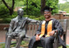 Graduate Spotlight: Samuel Pulapakuri Samuel Pulapakuri, in cap and gown, sits smiling on a bench next to the Jesse Mercer statue in Atlanta.