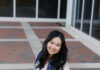 Graduate Spotlight: Cathy Le Woman in a white dress kneeling on brick pavement, holding a bouquet, wearing a sash that reads Vice President.