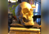 In remembering that we die, we learn how to live | Dr. Greg DeLoach A realistic skull model rests atop three books titled Corpse Care, Being Mortal, and The Christian Art of Dying.