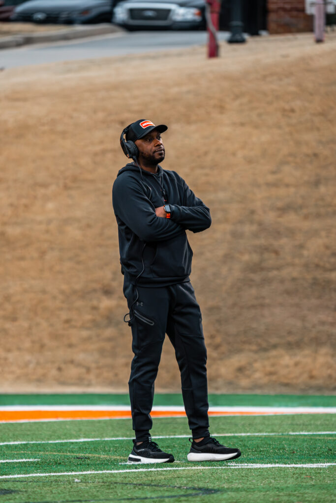 Joel Taylor sports field with arms crossed, facing forward.