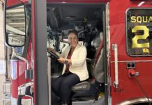 Honeywell engineer learned communication skills, curiosity from Mercer Katie Davis sits in the driver’s seat of a red fire truck inside a fire station.