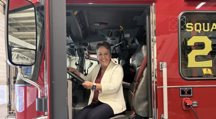 Honeywell engineer learned communication skills, curiosity from Mercer Katie Davis sits in the driver’s seat of a red fire truck inside a fire station.