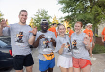 4 things to know about Mercer’s 2026 Opening Days and Bear Beginnings Four students in Mercer University shirts pose and smile outdoors during move-in day, with others in the background.