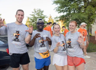 4 things to know about Mercer’s 2026 Opening Days and Bear Beginnings Four students in Mercer University shirts pose and smile outdoors during move-in day, with others in the background.