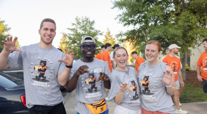 4 things to know about Mercer’s 2026 Opening Days and Bear Beginnings Four students in Mercer University shirts pose and smile outdoors during move-in day, with others in the background.