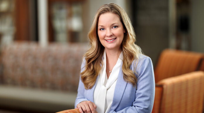 Dr. Stephanie Beavers named senior associate dean of medical school’s Macon campus Dr. Stephanie Beavers in a light blue blazer standing and smiling in the Macon campus lobby.
