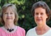 Mercer College of Pharmacy bids farewell to 2 longtime faculty members Two women stand outdoors in front of greenery, both facing the camera and smiling slightly.