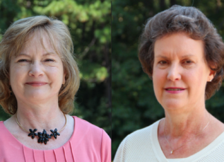 Mercer College of Pharmacy bids farewell to 2 longtime faculty members Two women stand outdoors in front of greenery, both facing the camera and smiling slightly.