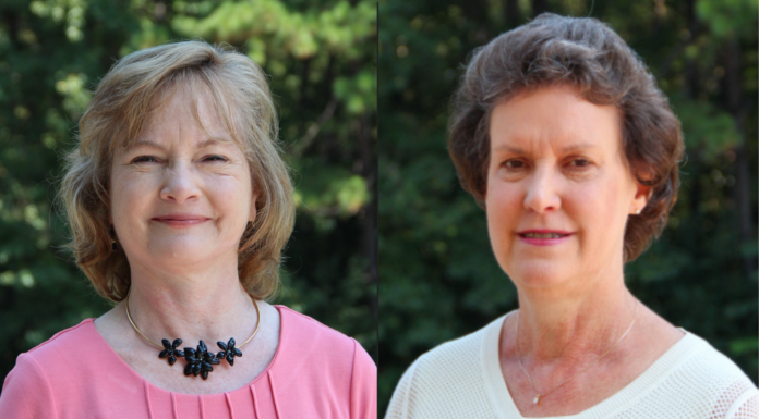 Mercer College of Pharmacy bids farewell to 2 longtime faculty members Two women stand outdoors in front of greenery, both facing the camera and smiling slightly.