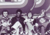 Alan Walden’s influence reached from Mercer to Macon and beyond Four men sitting on a patterned couch in front of a geometric backdrop, all facing the camera and smiling.