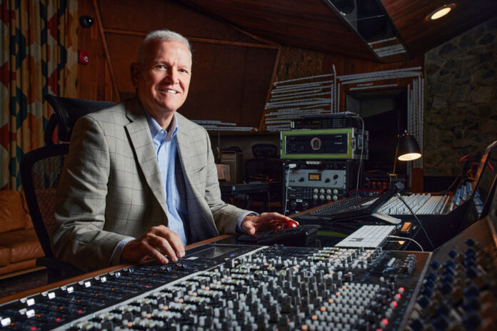 full-3 Gary Gerber sits at a large audio mixing console in Capricorn Sound Studios.