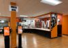 What’s new with Atlanta campus dining this year Fast food restaurant interior with self-order kiosks, serving counter, and bear mascot wall art.