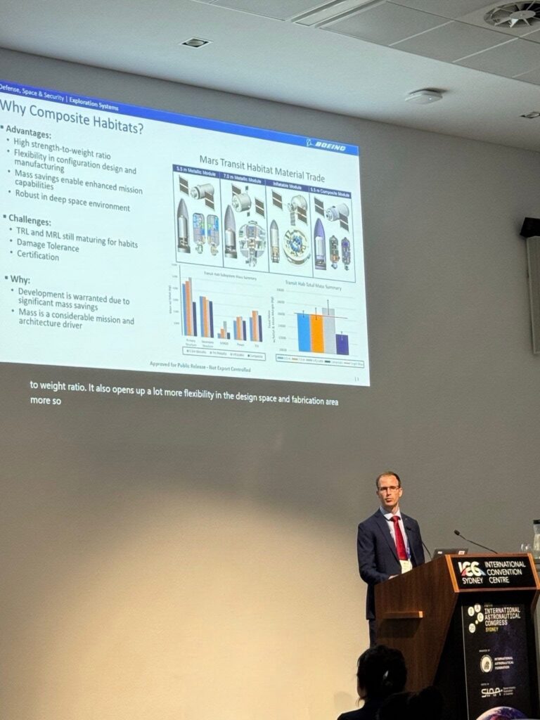 Matthew Ziglar presents a slide about composite habitats at a conference, showing diagrams, charts, and bullet points on the screen.