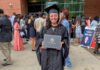 Mercer alumna creates home services directory for women Alicia Hernandez holds a diploma outside a building, surrounded by people at a graduation ceremony.
