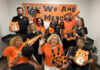 Show your Mercer spirit each week during Be the Bear Fridays This enthusiastic group in Mercer gear poses with pom-poms, banners, and signs, showing school spirit for the Mercer Bears.
