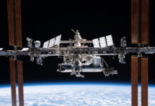 Engineering alumnus helping lead the way in space exploration The International Space Station orbits above Earth with solar panels extended against the blackness of space.