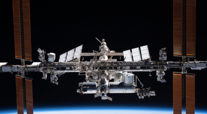 Engineering alumnus helping lead the way in space exploration The International Space Station orbits above Earth with solar panels extended against the blackness of space.