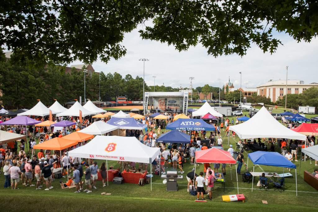 Crowd gathers among colorful tents on Black Field.
