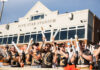 3 things to know about Mercer vs. Presbyterian football game day: Sept. 5, 2026 A group of fans with painted chests and foam sticks cheer in front of Five Star Stadium on a sunny day.