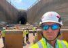 Alumnus supports water projects as district deputy for Corps of Engineers A group of workers in safety vests and helmets stand near a large tunnel under construction; one man is in the foreground.