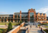 Mercer University reveals first look at new student life center Artist rendering of a large brick academic building with tall windows and landscaped paths on a sunny day.