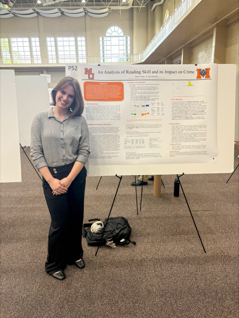 Addie White standing and smiling next to a research poster titled An Analysis of Reading Skill and Its Impact on Crime.
