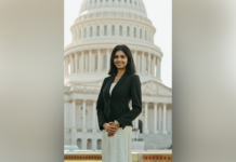 Shafa Gilani Selected as 2026–27 Newman Civic Fellow A woman in business attire stands in front of the U.S. Capitol building, smiling at the camera.