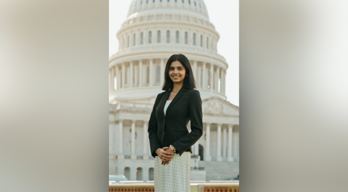 Shafa Gilani Selected as 2026–27 Newman Civic Fellow A woman in business attire stands in front of the U.S. Capitol building, smiling at the camera.