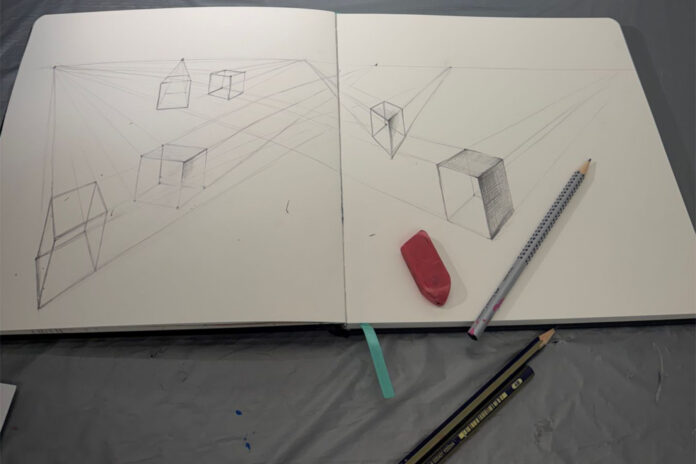 Open sketchbook with perspective cube drawings, an eraser, and two pencils on a gray surface.