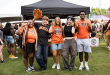 3 things to know about Mercer vs. Western Carolina football game day: Oct. 10, 2026 Five students in Mercer University gear making bear claw hand gestures in front of a tent.