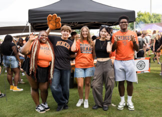 3 things to know about Mercer vs. Western Carolina football game day: Oct. 10, 2026 Five students in Mercer University gear making bear claw hand gestures in front of a tent.
